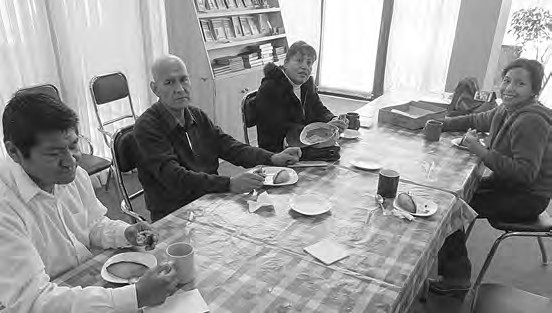 Four members of the La Paz ecclesia seated at a table